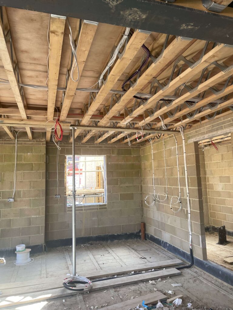 Alt text: First-fix electrical wiring installed in a new-build house